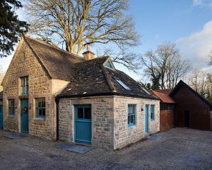 Exterior: where the original stone 19th century cottage meets the modern steel extension. Modern extension meets 19th C stone cottage. Gasworks Cottage by Chris Dyson Architects. Photography: Peter Landers