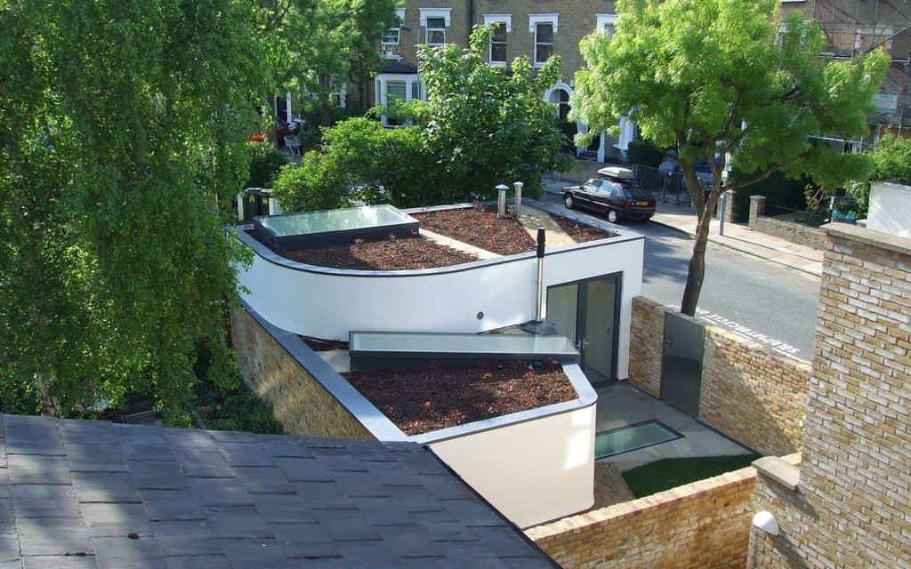 30 Cardozo Street (2013) by Jack Wooley is a partially subterranean house built to preserve the existing long view across the site from street level.