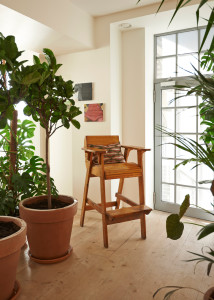 An antique Danish desk and Clam chair by Philip Arctander. Flowers are by Fjura