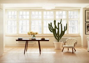 An antique Danish desk and Clam chair by Philip Arctander. Flowers are by Fjura