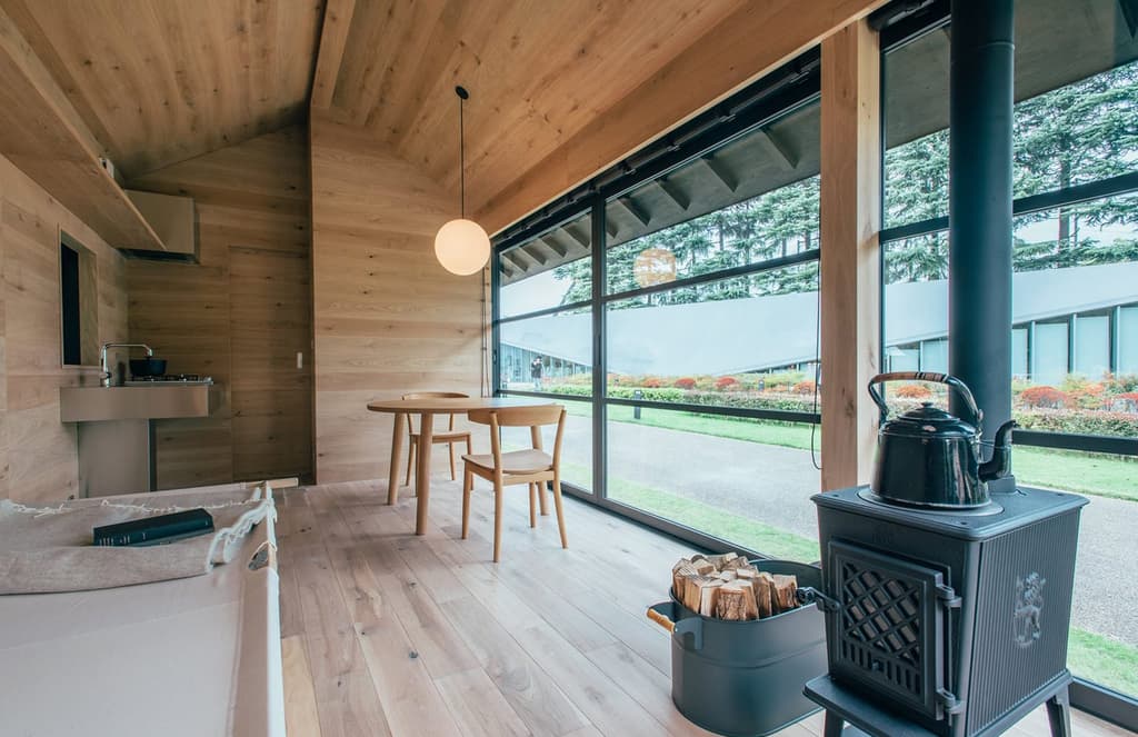 Muji unveils prefab huts designed by Morrison, Grcic and Fukasawa