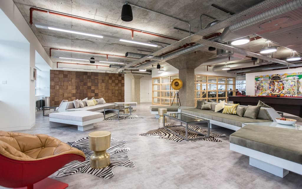 Seating area for VIP personal shopping clients is kitted out like an informal lounge, with a variety of seating inspired by John Lautner's mid-century designs.