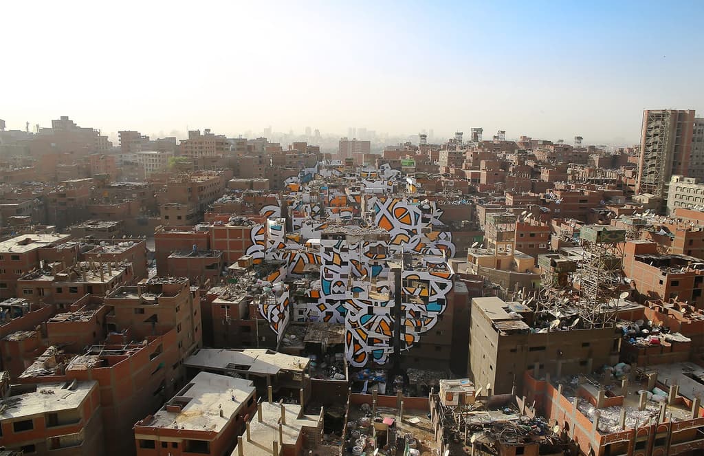 Street artist eL Seed paints a mural across 50 Cairo buildings
