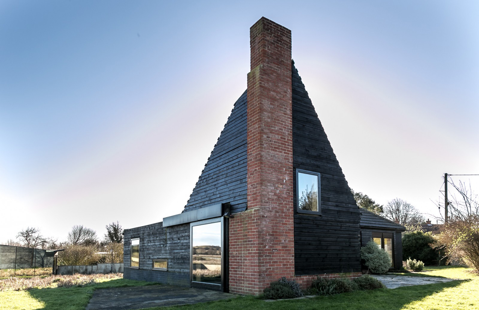 An angular brick and timber house on the Norfolk coast is available for £695,000