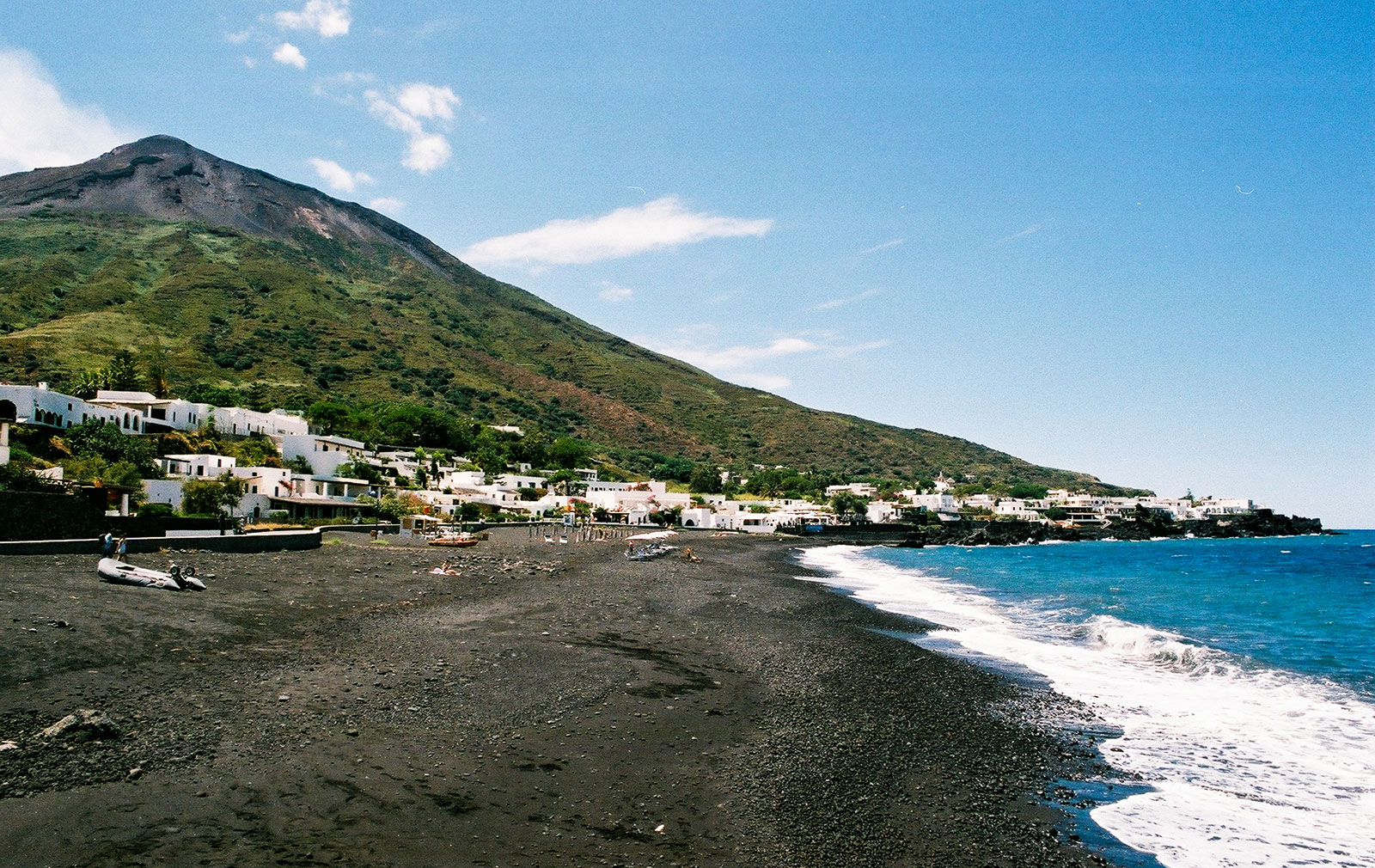 Black volcanic sands line the beach at the small beachfront village of Ficogrande on Stromboli
