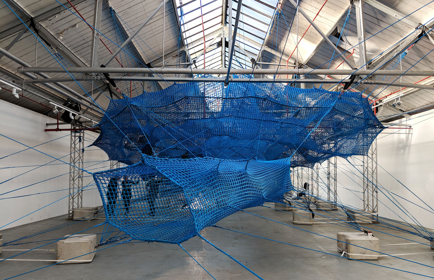 Arts collective Numen/For Use weaves a giant net inside London’s Brewer Street Car Park