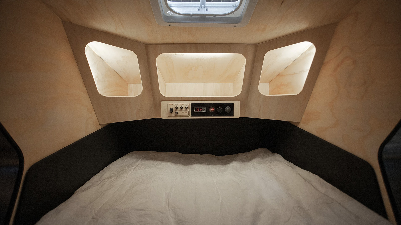 The Polydrop camper has pared back interiors with built-in cubby holes for storage and a panel for controlling LED lighting