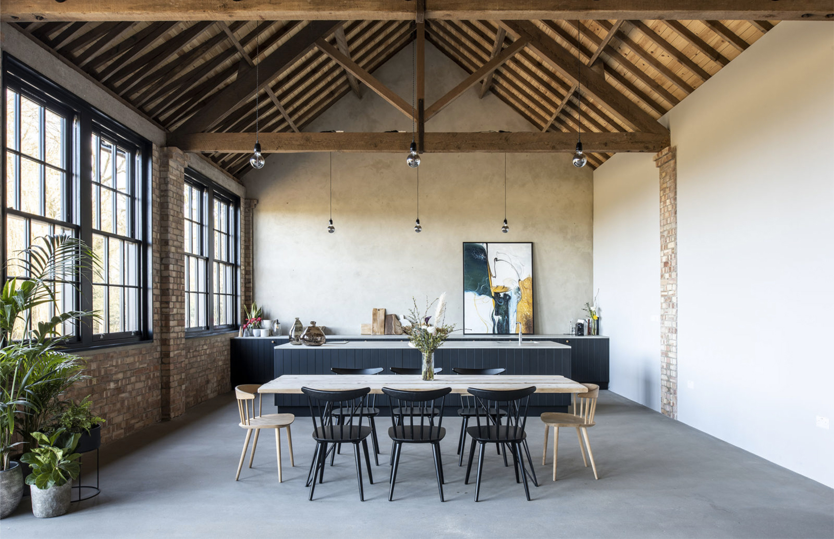 Masterfully converted in the Suffolk Countryside is this former diary barn which features trussed ceilings, bricks and concrete floors