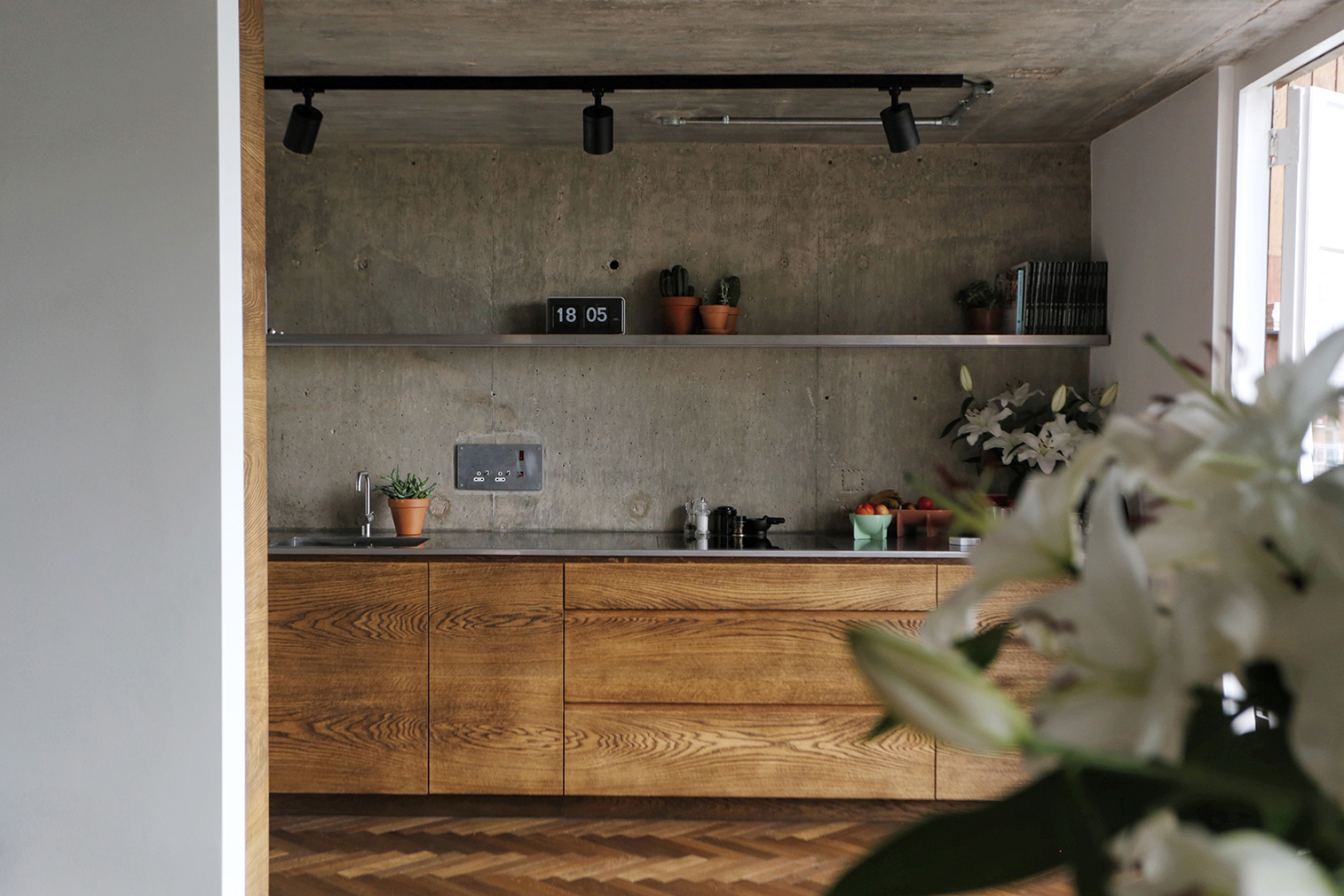 The kitchen and living room have glazed end walls with views over plane trees and direct access to its full-length balcony.