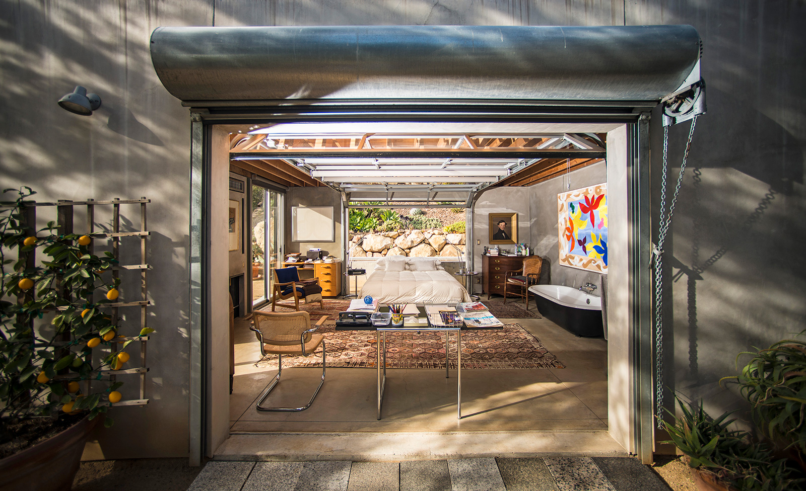 A view through the guest house at Barton Myers's estate. The smaller dwelling mimicks the style of the main residence, with an industrial aesthetic that contrasts the greenery of the estate's canyon setting