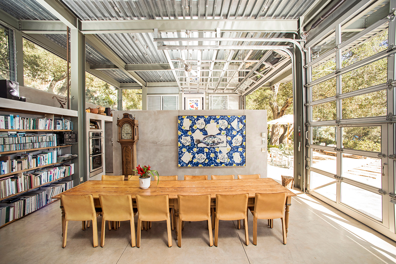 Inside Barton Myers' industrial Santa Barbara home. It feautres rolling garage door walls that open to the elements, as well as a fixed steel-beam frame and corrugated steel roof.
