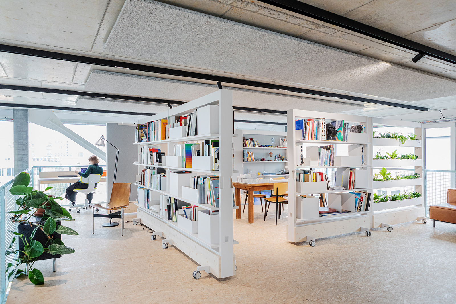 StudioHūrlemann's Dancing Wall for Vitra– a movable partition and storage solution mounted on wheels. Photography: Dejan Jovanovic