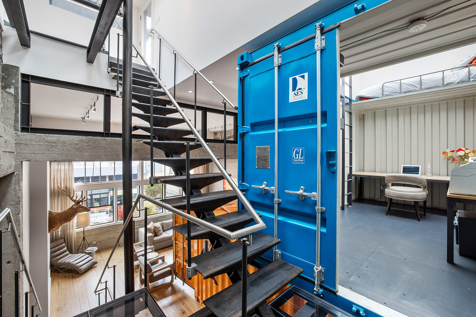 Stacked shipping containers sit inside this sprawling warehouse loft in San Francisco's Fillmore District, juxtaposing industrial brick bones with rugged steel.