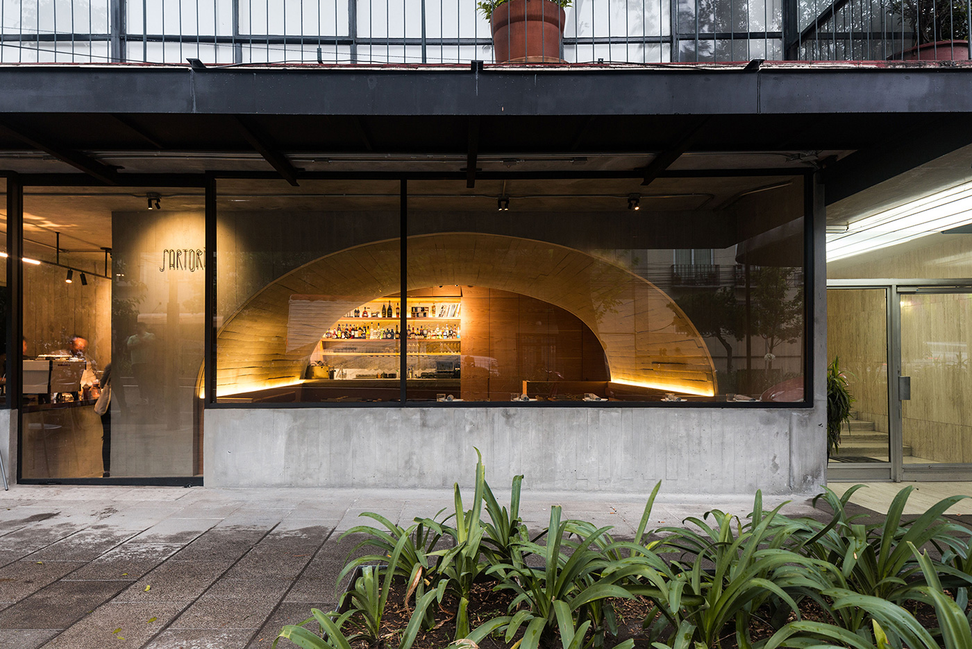 Sartoria offers a contemporary take on Europe's vaulted taverns, serving fresh pasta inside a glowing concrete tunnel in Mexico City's Roma Norte neighbourhood.