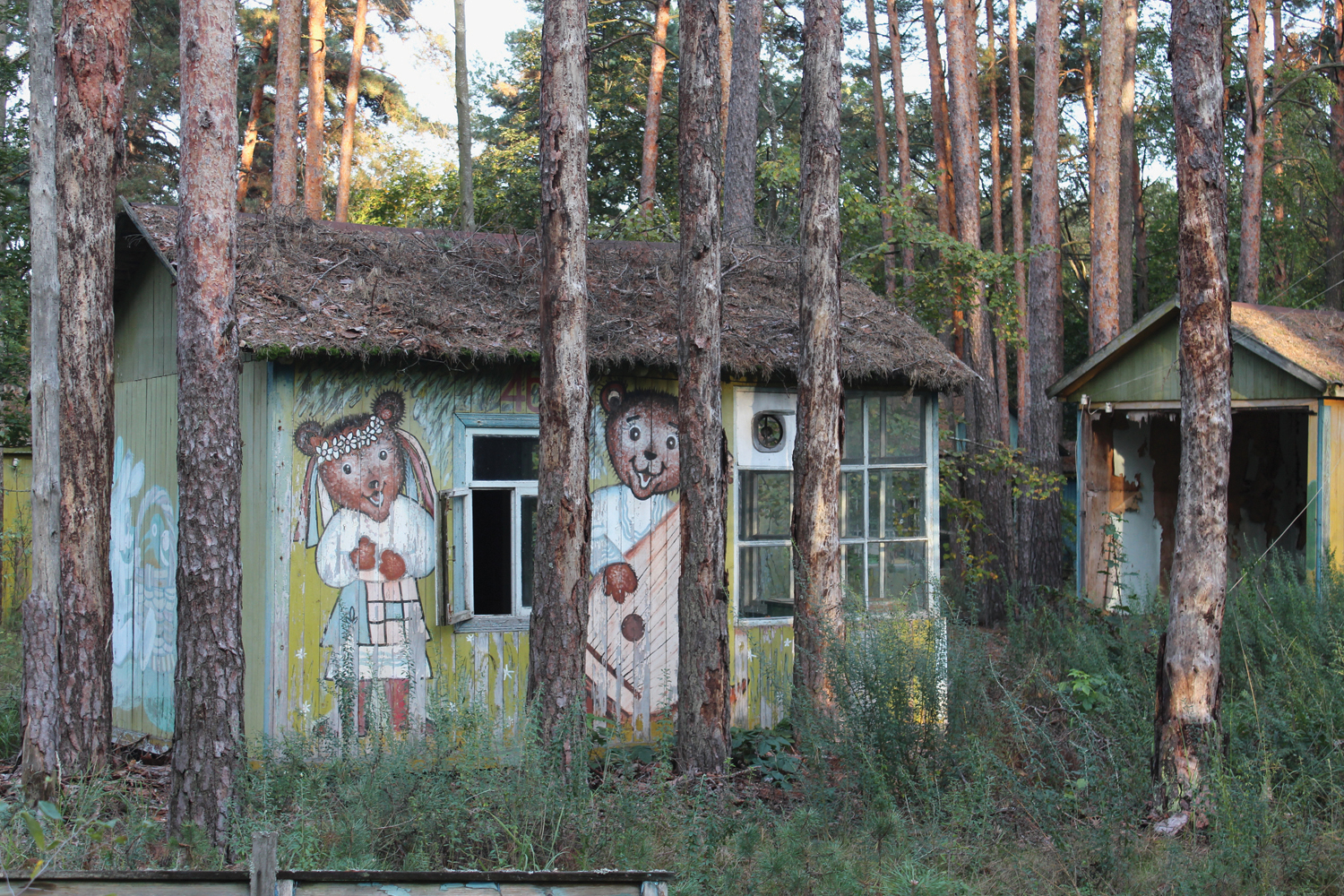 Izumrudniy’ (‘Emerald’) Holiday Camp, near Chornobyl. Once a popular spot for summer holiday breaks, these rustic wooden chalets, painted with characters from cartoons and fairy tales, were completely destroyed by forest fires in April 2020. © Darmon Richter / FUEL Publishing