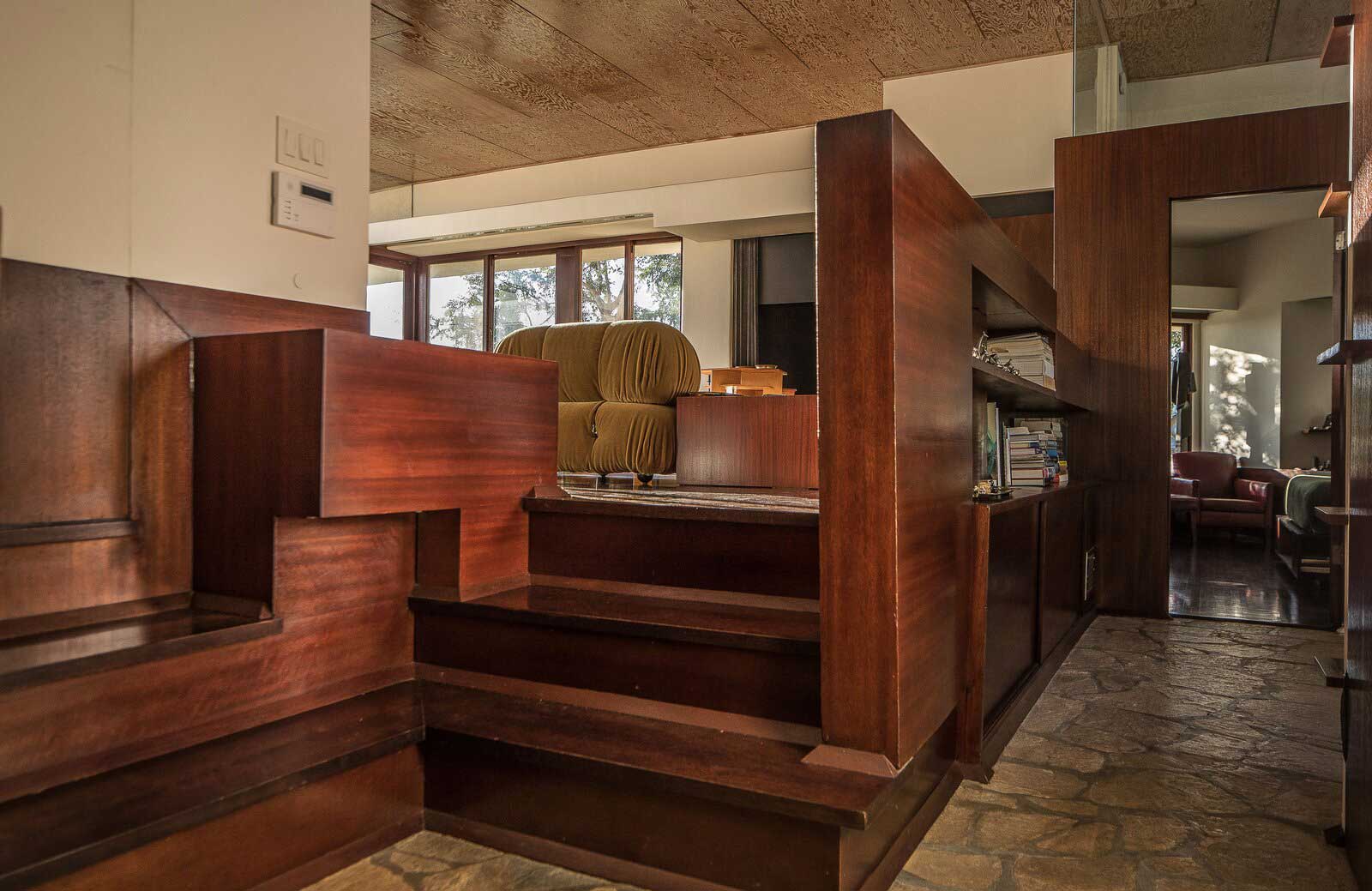 The penthouse apartment has original mahogany cabinetry and stairs, as well as period plywood ceilings