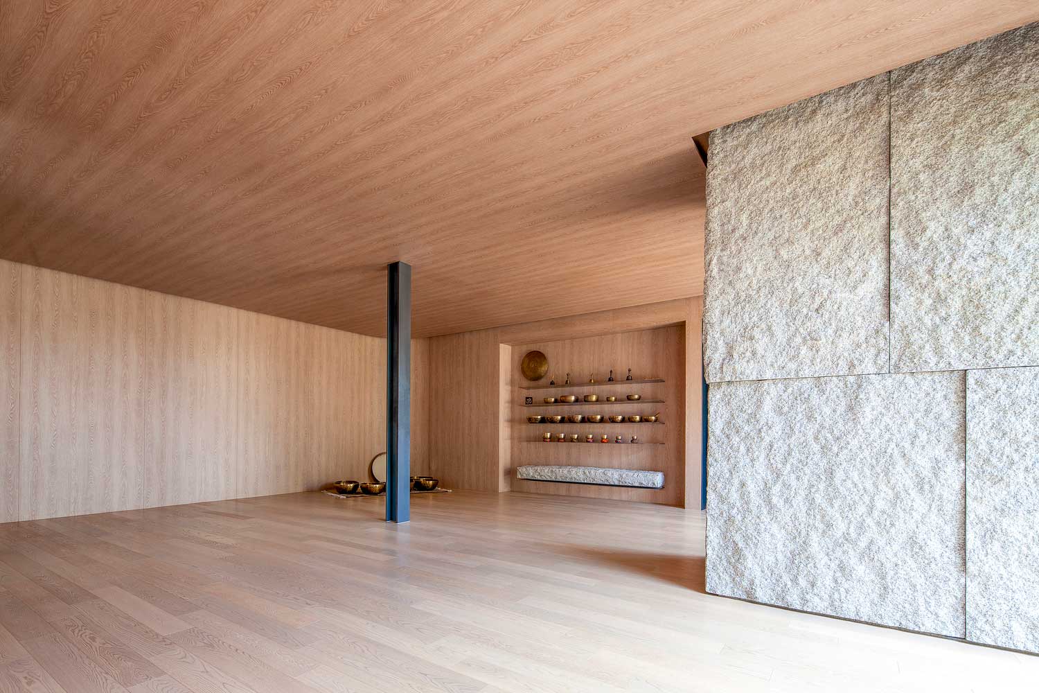 The Yoga studio uses a range of textures to enliven the five senses: wooden ceilings, concrete pullars and steel supports also reflect the connection between the manmade and the natural