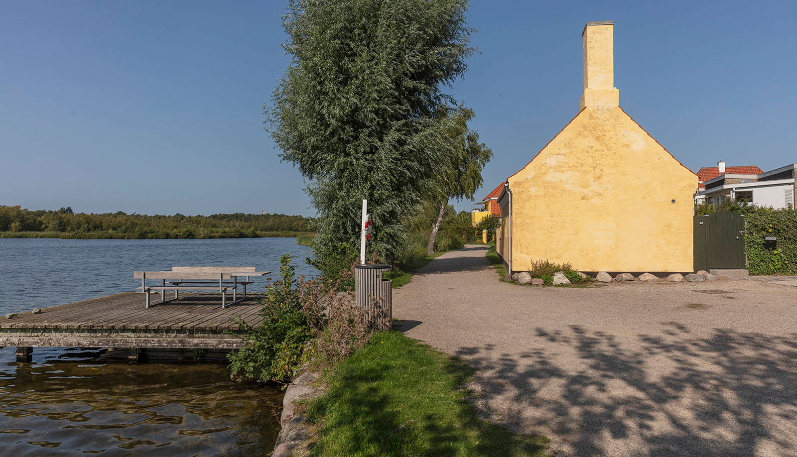 An architect's studio is now a modern home on Lake Gentofte's shores following a gentle renovation to polish its historic bones