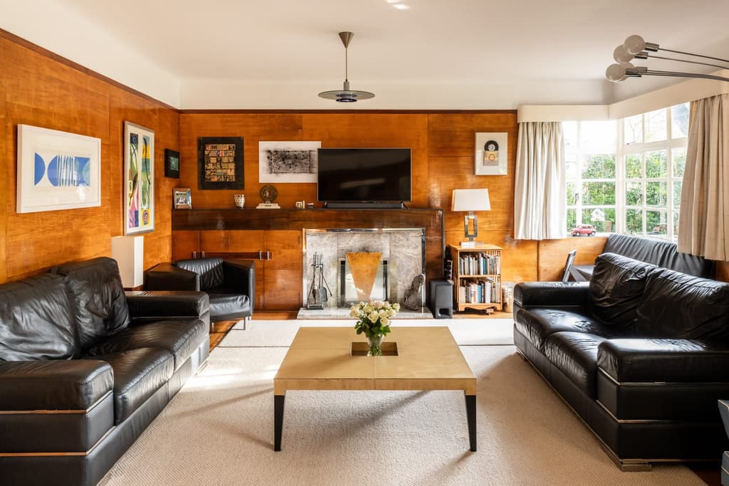 Living rooom with corner window and central fireplace