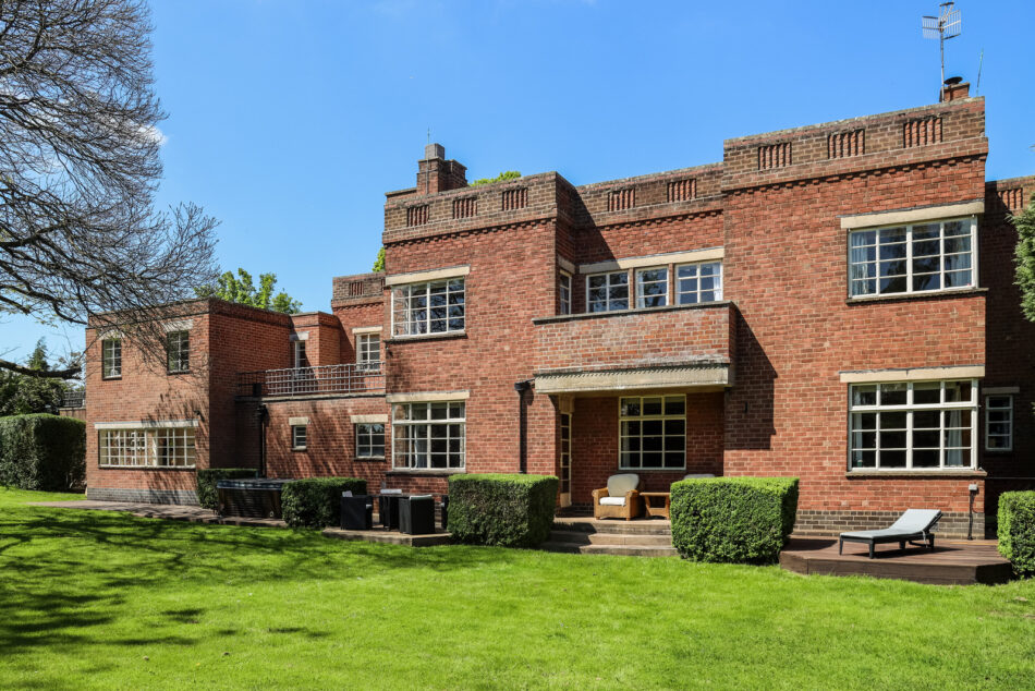 The exterior of the home is quite imposing and features large horizontal bands of Crittall windows
